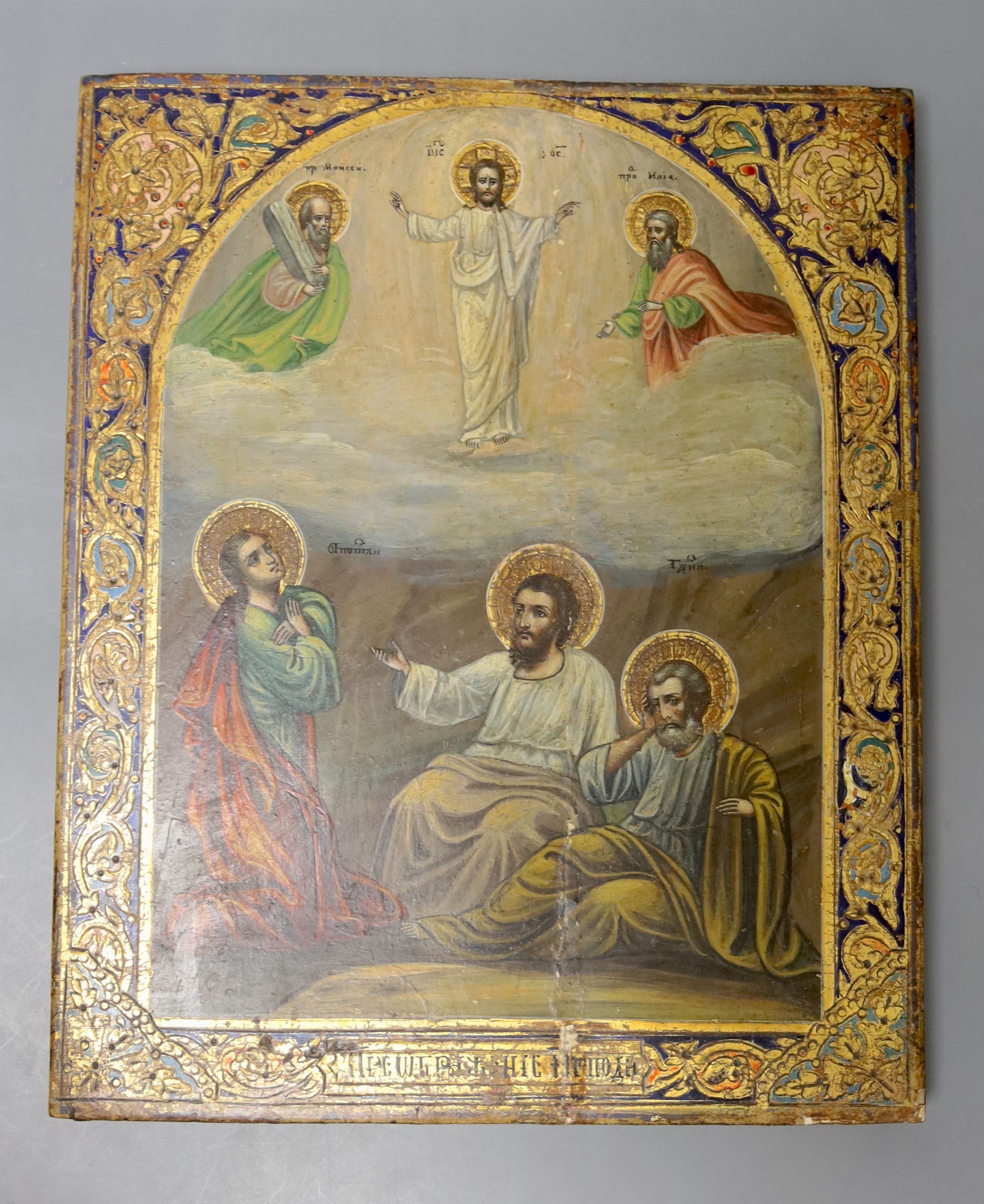 A Russian Icon, painted and gilt gesso panel, of six figures within an arched vignette